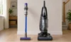 Cordless stick vacuum and corded upright vacuum side by side in a home.